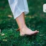 Varykozni vyrazky chomu vony vynykayut na tli khronichnoyi venoznoyi nedostatnosti | Медичний центр "Життя" Person walking barefoot on green grass, wearing light pants, outdoors near a park.